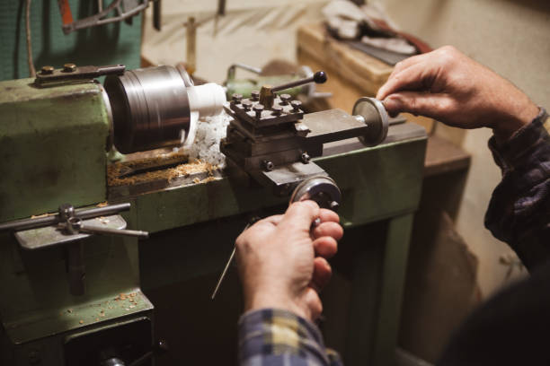 istock Man makes wood detail on lathe 639393428