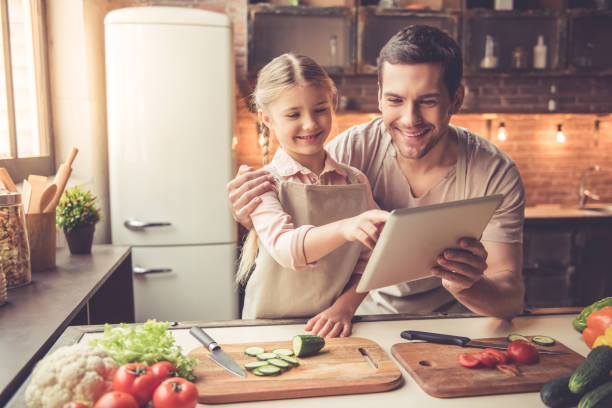 istock Father and daughter cooking 639394406