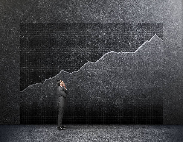 istock Businessman Looking Up At Growth Chart On Wall 639396162