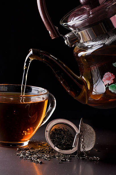 istock cup of tea with teapot on dark background 639396540