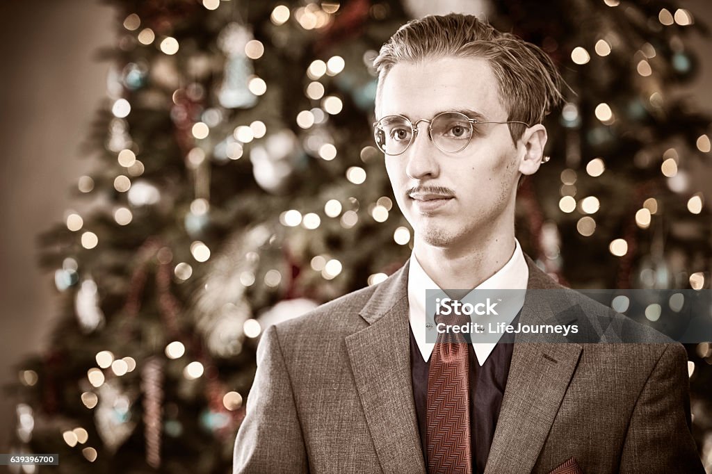 Banker from 1940's Christmas Portrait Prominent 1940's town banker standing in front of the banks Christmas Tree.  Looks relaxed as he gazes off left of image.  Copy Space.  Vintage.. Fame Stock Photo