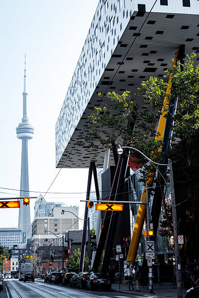Sharp Centre for Design, Ontario College of Art Toronto, Canada - September 5, 2015: Low-angle view of the modern expansion of the Sharp Centre for Design at the campus of the Ontario College of Art (OCAD) in downtown Toronto, with the CN tower in the background. The building consists of an elevated white and black box supported by a series of multicolored inclined pillars. ocad stock pictures, royalty-free photos & images