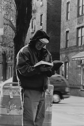 New York, NY, USA – March 17, 2010:Man reading in Jackson Heights, New York