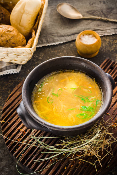 istock Soup in clay bowl on chopping board. 639400760