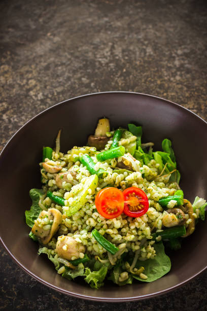 istock Pearl barley, green beans, tomato salad on ceramic plate 639401378