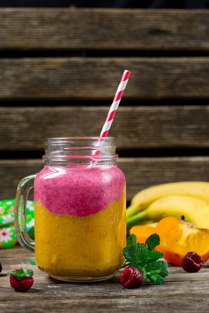Two layer smoothie with persimmon, banana and raspberry