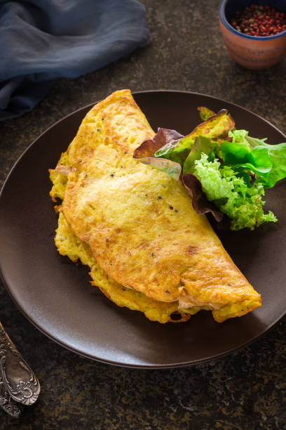 istock Omelet and green salad on ceramic plate. 639401918