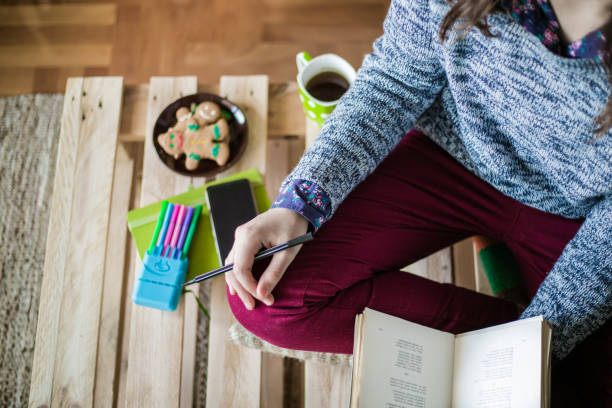 istock Pretty young student reading at home 639402520