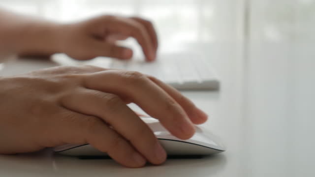Businesswoman Hands typing on keyboard and clicking a computer mouse