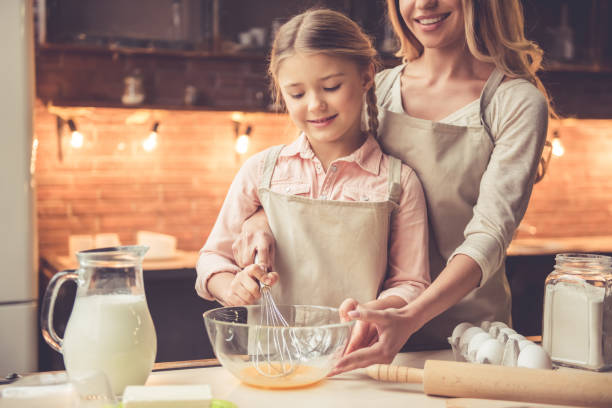 istock Mother and daughter baking 639404182
