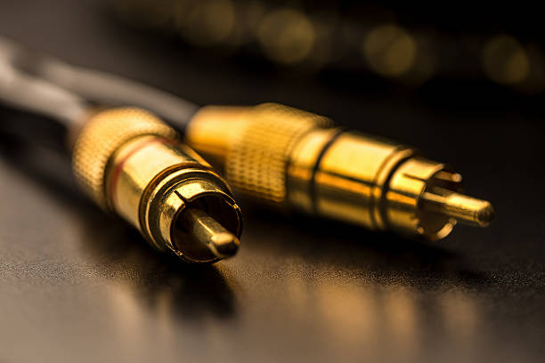 High-frequency coaxial video cable adapter with silvery connectors BNC and RCA on the edges on a gray surface