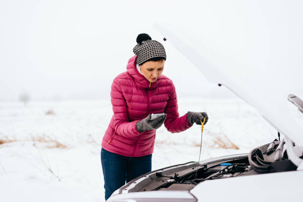 Woman calling for help or assistance - winter car breakdown