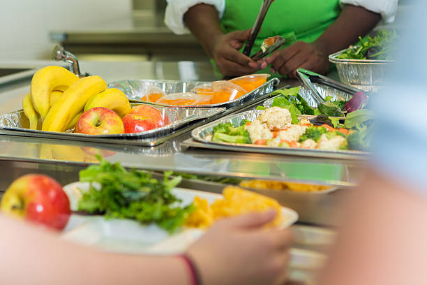 close up of students being served in high school cafeteria - tray lunch education food imagens e fotografias de stock