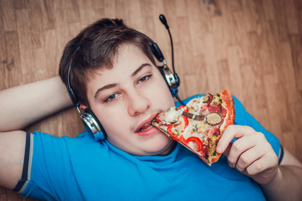 istock Teenager eating pizza. 639408734