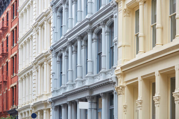 Ancient buildings facades with columns in New York Ancient buildings facades in beige, blue, white and red colors with columns in New York soho new york stock pictures, royalty-free photos & images