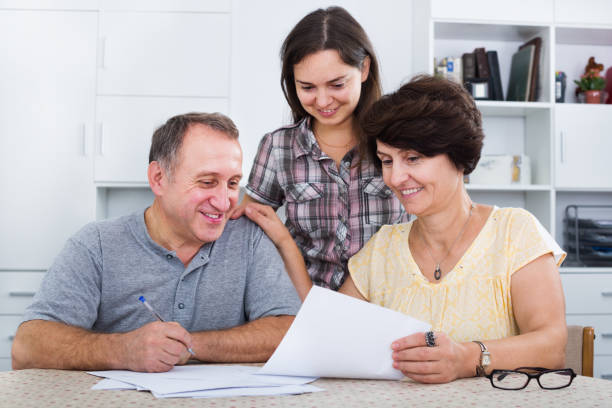 istock Daughter helping with documents to parents 639410182