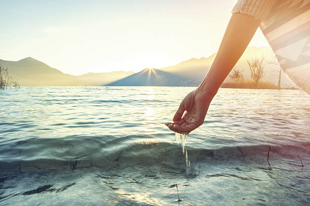 istock Human hand cupped to catch fresh water from lake 639412308