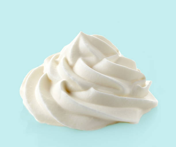 whipped cream on blue background - whipped cream imagens e fotografias de stock