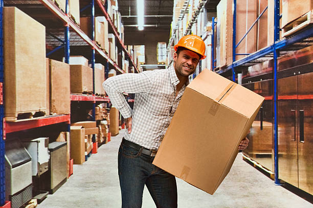 istock Smiling worker feeling back pain in warehouse 639419302