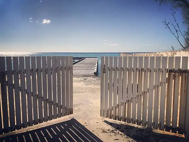 Fence and ruined pier in Cockburn Town, Turks and Caicos