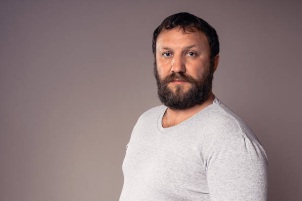 istock Handsome bearded man in gray t-shirt looking at camera. 639422926