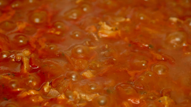 istock bacon tomato onion carrot and paste in a pan closeup 639424788
