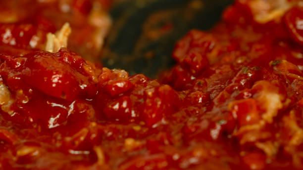 istock bacon tomato onion carrot and paste in a pan closeup 639425576