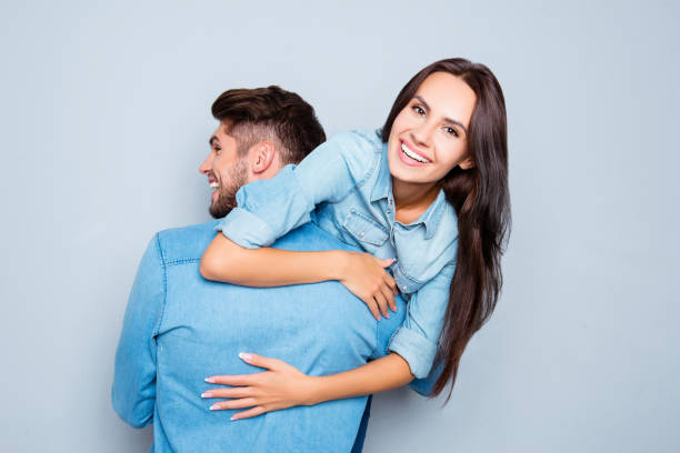 istock Happy man carrying his joyful girlfriend on the back 639425682