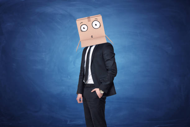 istock Businessman is wearing cardboard box on his head with a 639425688
