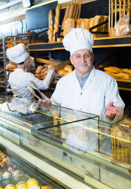 istock two bakers at the counter at bakery 639428866