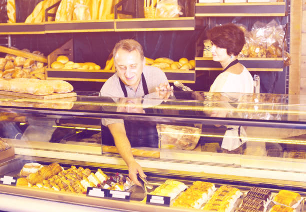 istock two bakers at the counter at bakery 639429088