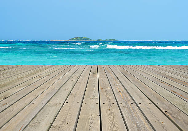 istock Wooden terrace beside tropical sea 639430854
