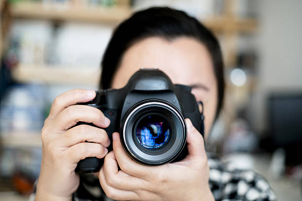 istock female photographer taking pictures 639431012