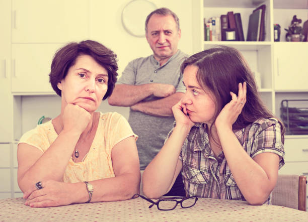 istock Woman sitting and looking sadly while talking with parents 639431244