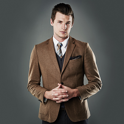 Studio shot of a young businessman against a dark background