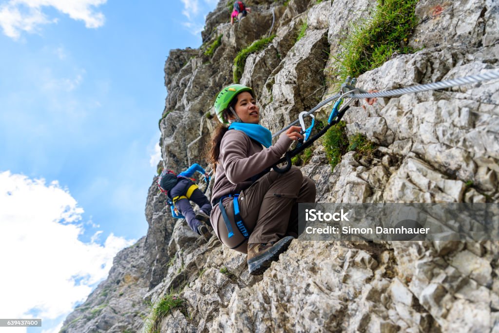 Hiker climbing in the mountain of Alps, Europe Hiker climbing in the mountain of Alps, Europe - extreme sports Climbing Stock Photo