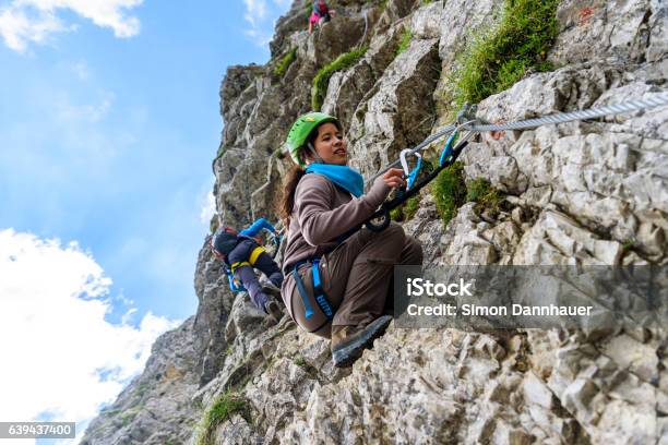 Hiker Climbing In The Mountain Of Alps Europe Stock Photo - Download Image Now - Climbing, Safe - Security Equipment, Teenager