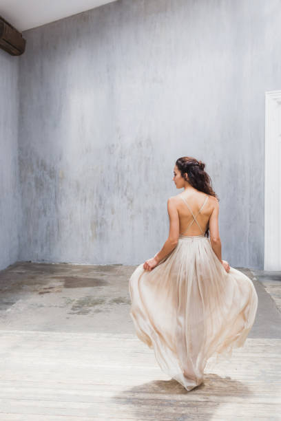 istock Bride with long black hair in studio, photo from back 639440648