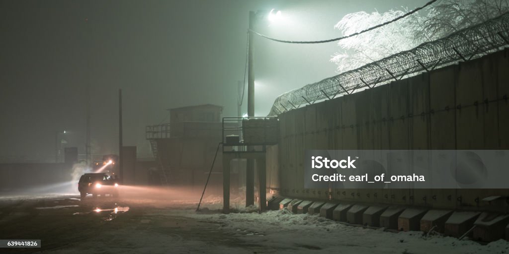 Afghanistan Military Patrol in Winter Military patrolling the outer wall of the base in Bagram Afghanistan Military Base Stock Photo