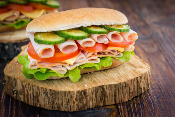 istock Turkey Ham Sandwich With Cheese, Tomatoes, Cucumbers and Salad 639445056