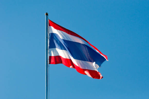 istock blurred Thai or siam flag with pole on blue sky 639445110