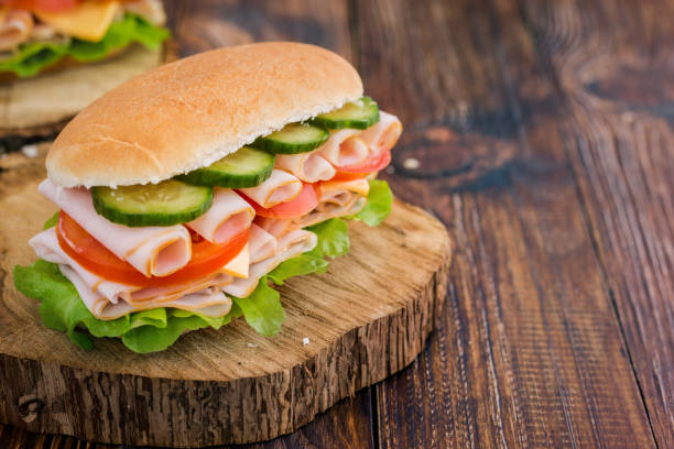 istock Turkey Ham Sandwich With Cheese, Tomatoes, Cucumbers and Salad 639445128