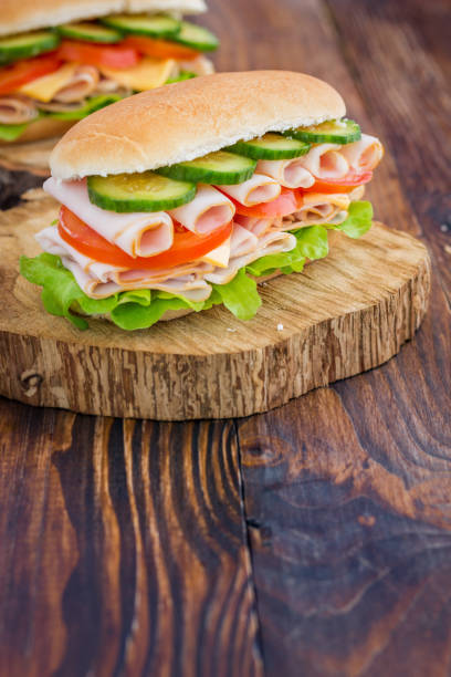 istock Turkey Ham Sandwich With Cheese, Tomatoes, Cucumbers and Salad 639445182