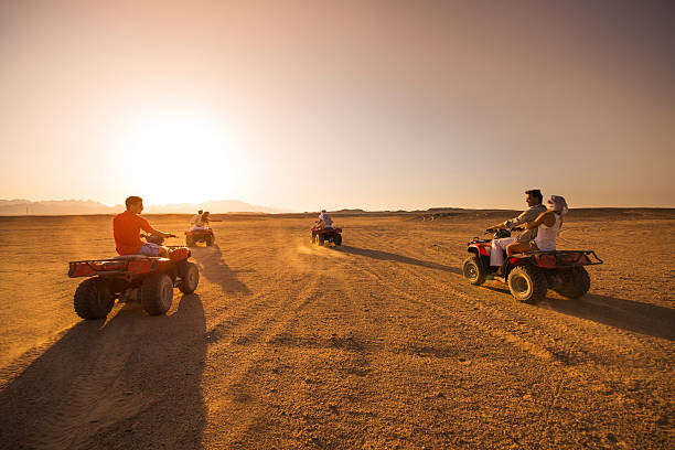 istock Young friends having fun on quad bikes at sunset. 639446308