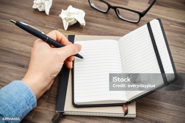 Woman Hand Writing On Notebook Stock Photo - Download Image Now - Left Handed, Writing - Activity, Women