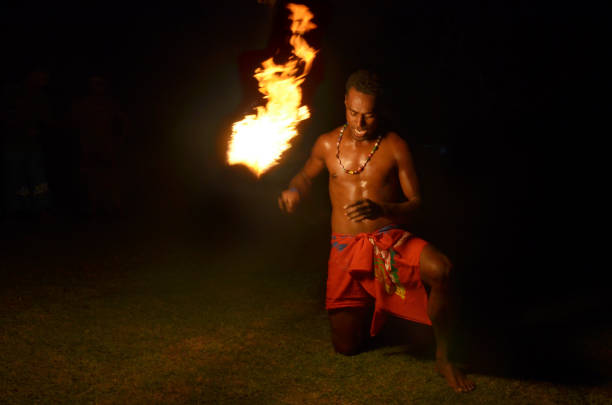 istock Indigenous Fijian man holds torch during a fire dance 639447722