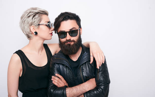 beautiful couple of bearded man and blond young woman young happy couple of blond woman with short hairstyle and handsome bearded man wearing leather rock jacket on white background men hairstyle beard coat stock pictures, royalty-free photos & images