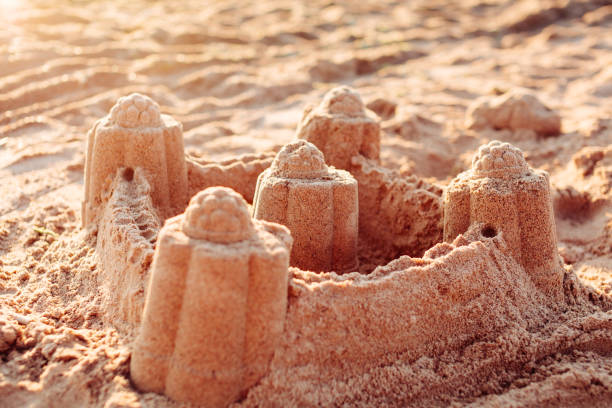 istock Sand castle tower. Child play and vacation concept. 639448488