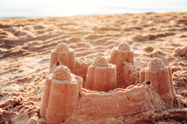 istock Sand castle tower. Child play and vacation concept. 639448974