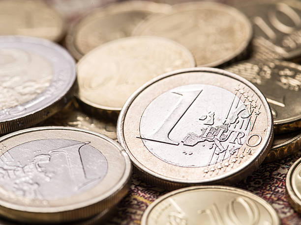 istock Euro coins over the old world map. 639449142